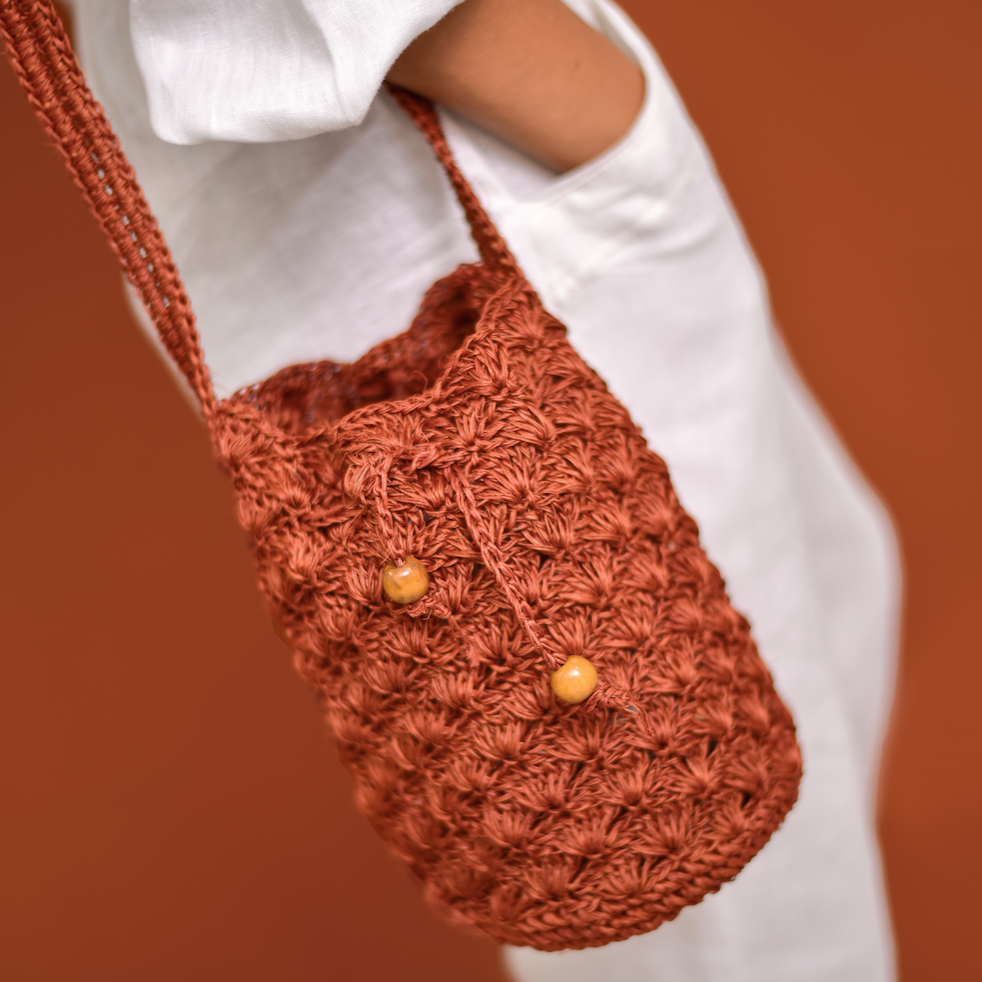 Mochila Abanico, bolso artesanal tejido a mano con material de fique por artesanos de Santander, Colombia. Su diseño único, inspirado en los abanicos tradicionales, combina un toque rústico y sofisticado. Ideal para quienes buscan moda auténtica, ecológica y con historia, esta mochila fusiona elegancia, tradición y sostenibilidad en cada detalle.