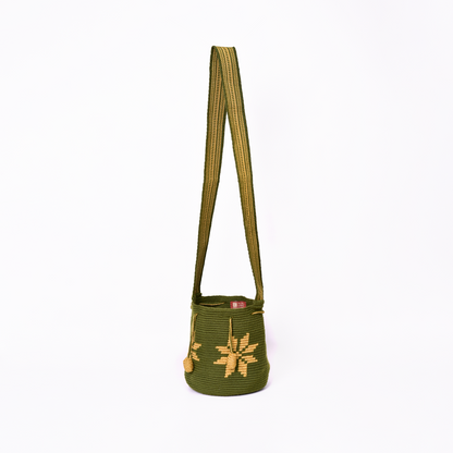 Mochila Marlen, mochila artesanal hecha a mano por artesanas de la comunidad Wayuu en el norte de Colombia. Tejida con hilos de algodón y seda dorada. Su diseño de flores tejidas aporta elegancia atemporal, mientras que su gasa larga y cordón ajustable. Mochila wayuu, mochila colombiana, bolso colombiano, bolso artesanal, mochila artesanal, color verde militar.